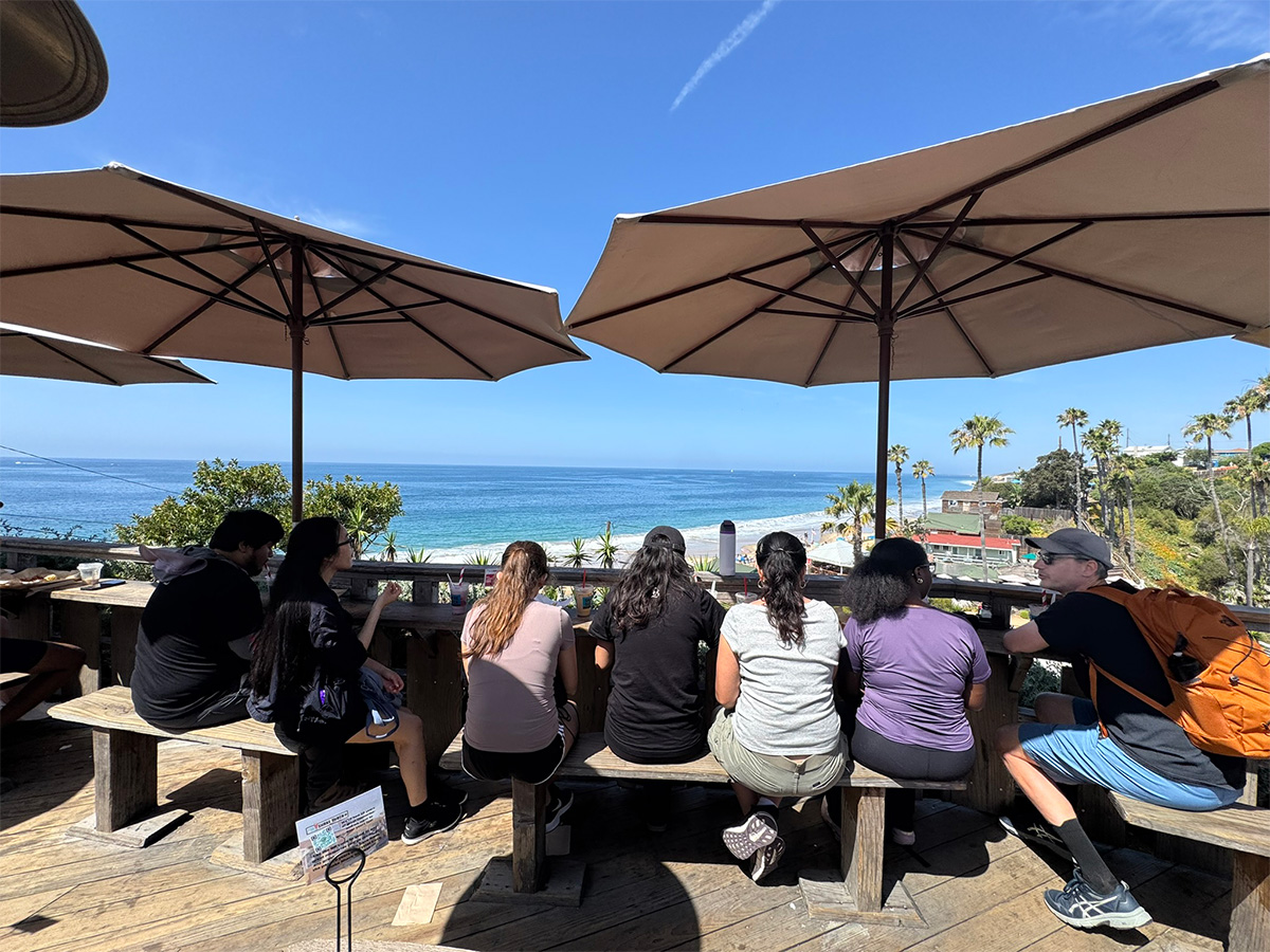 group enjoying refreshments while looking out at ocean
