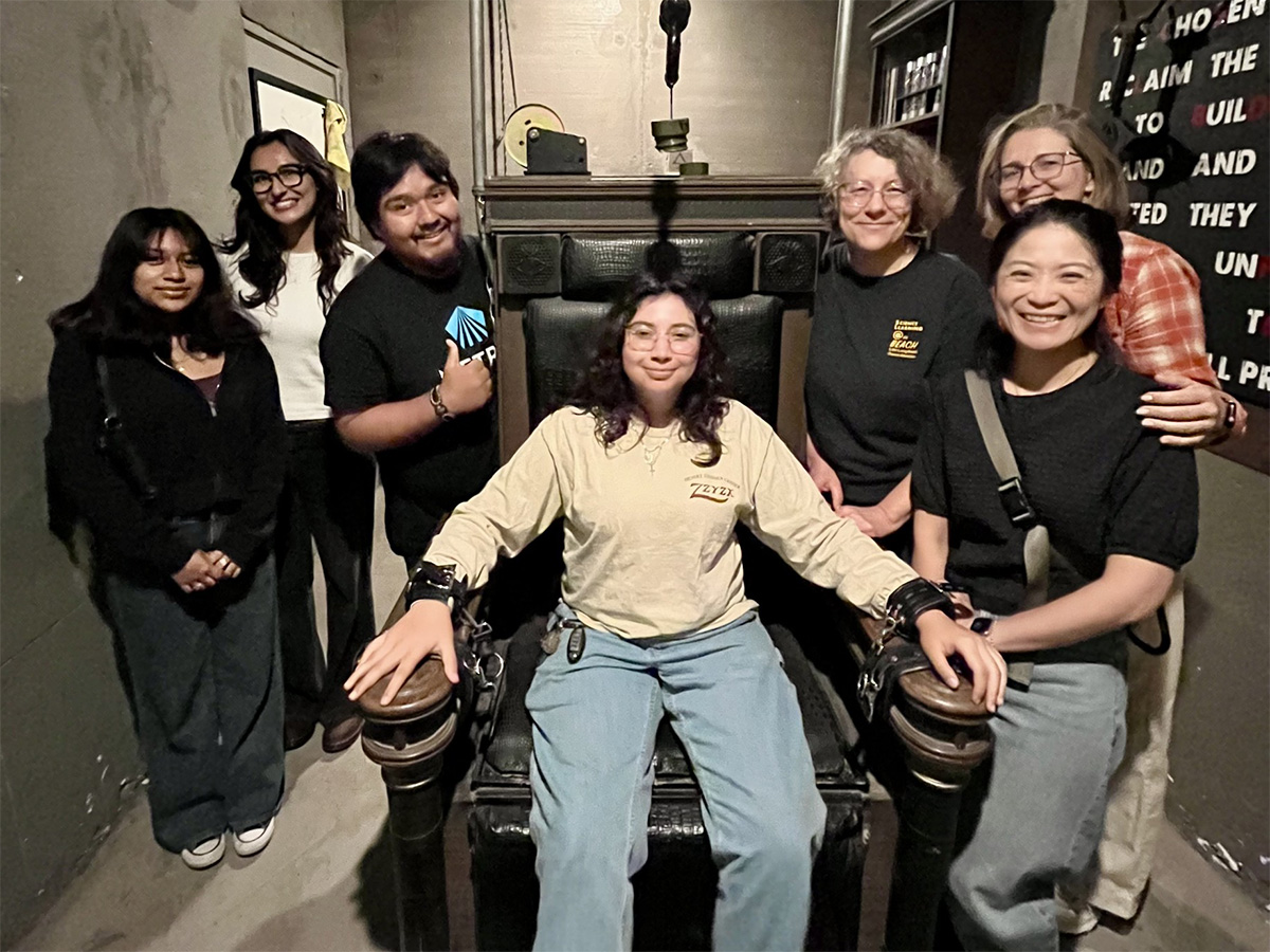 group 2 gathered around a participant pretending to be restrained to a chair