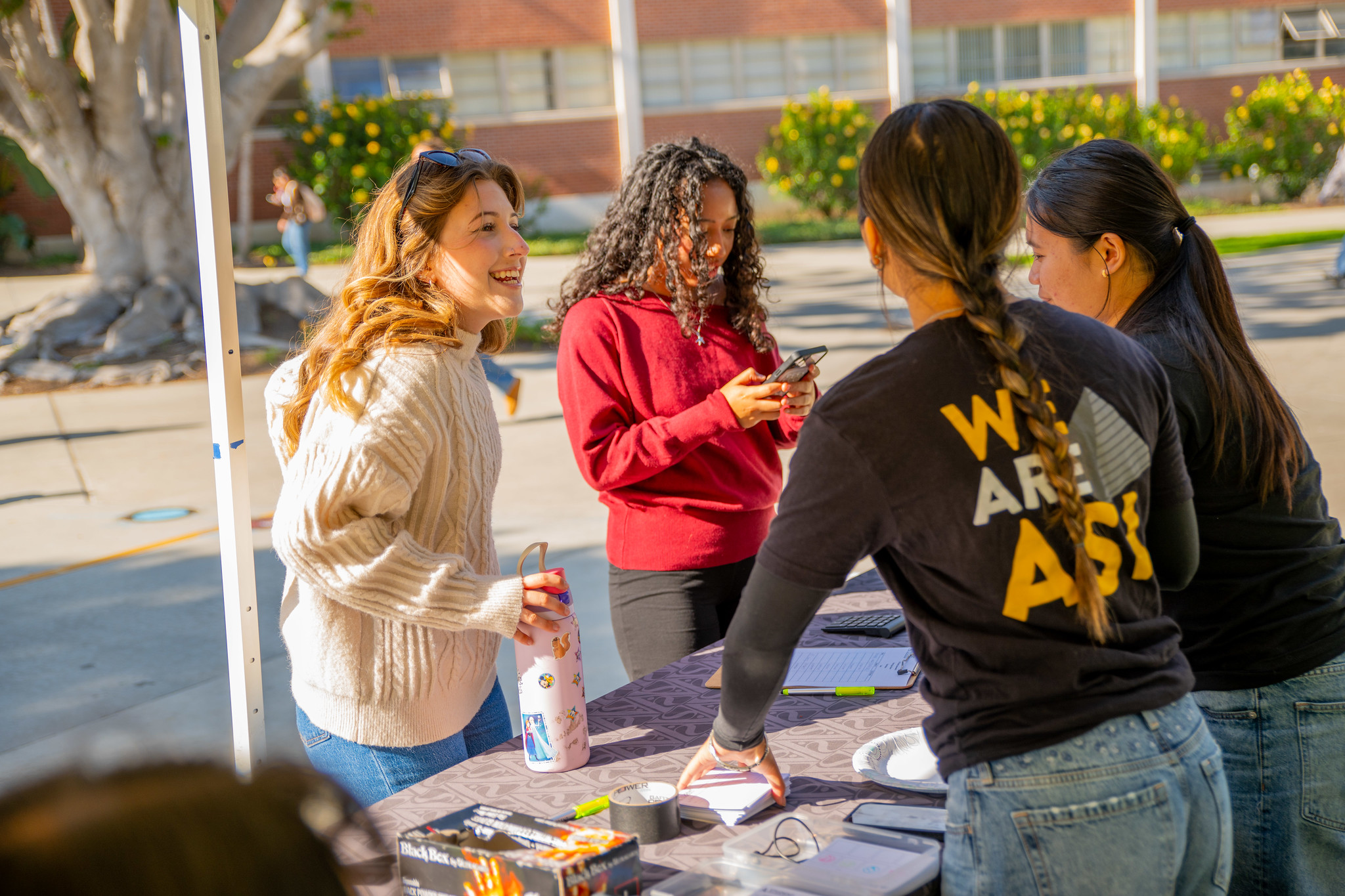 Staff at a booth providing resources to students.