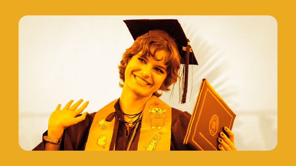Student smiling while holding diploma