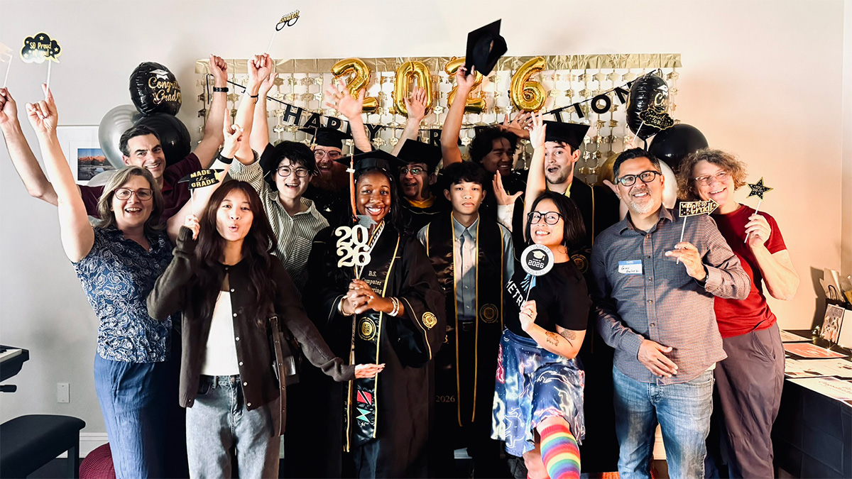graduates, mentors, family, and friends at the event