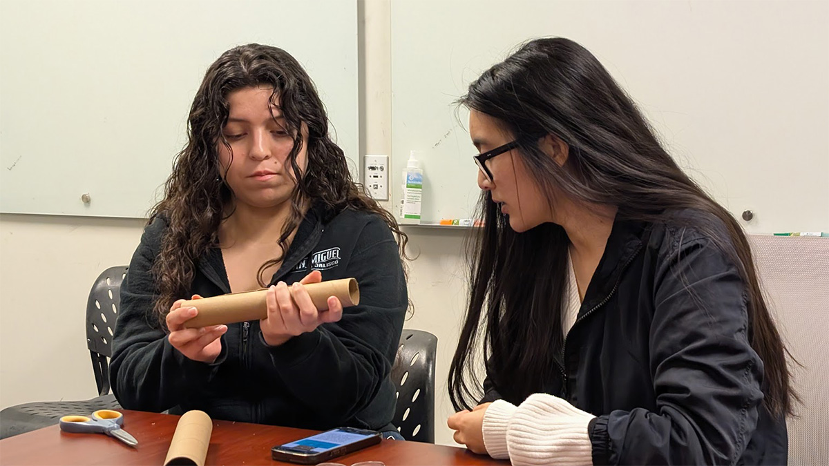 students building telescopes from cardboard tubes