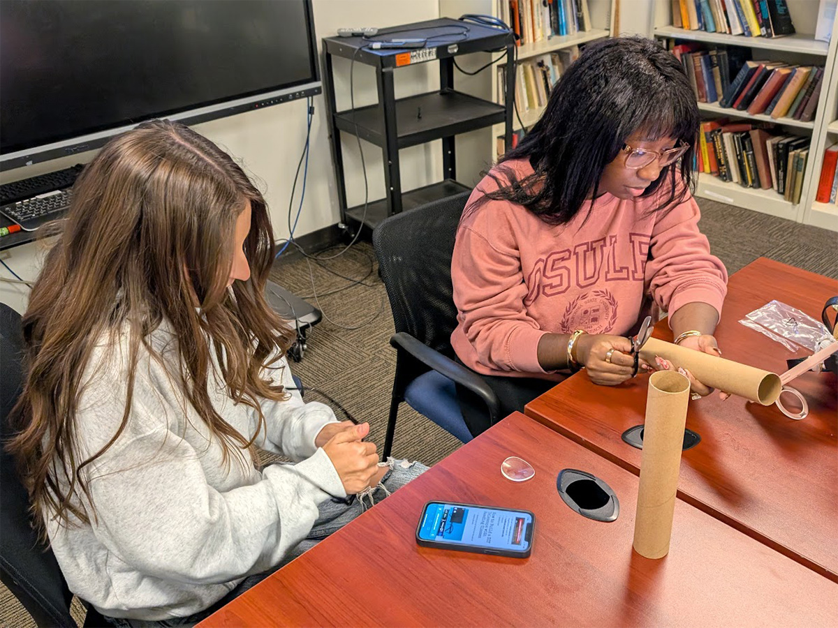 students building telescopes from carboard tube