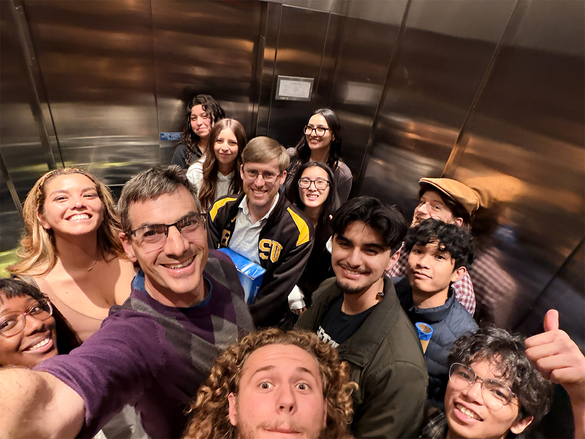 group smiling in elevator