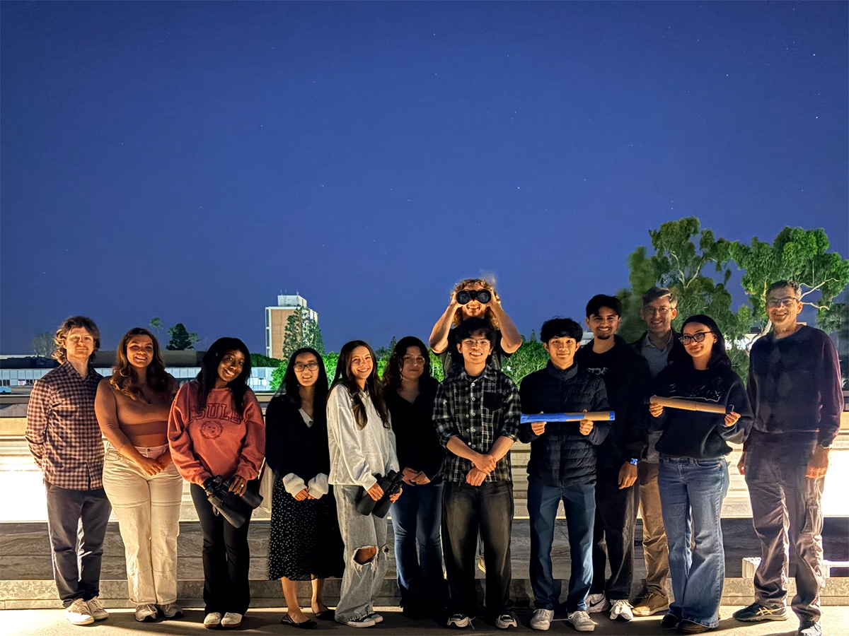 group on rooftop at night
