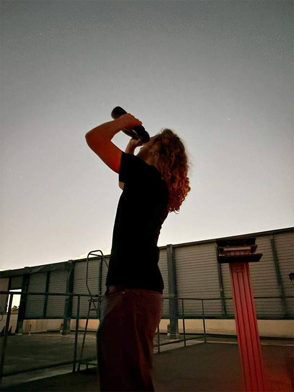 person using binoculars to look at night sky