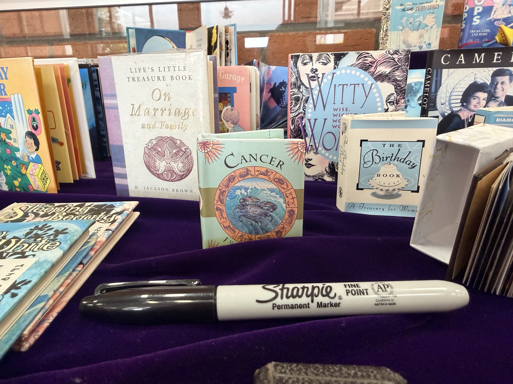 display of miniature books with a sharpie marker