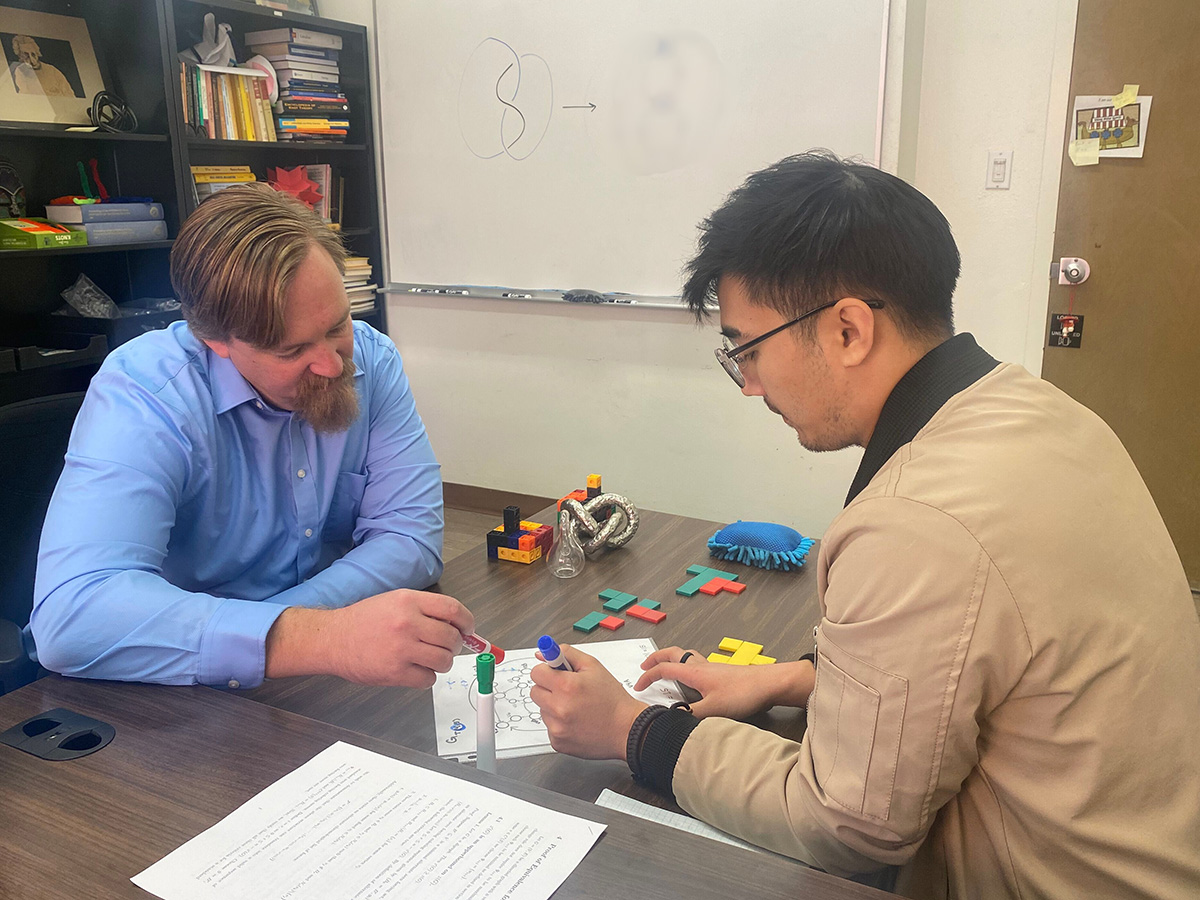 Dr. Ryan Blair and student researcher discussing knots