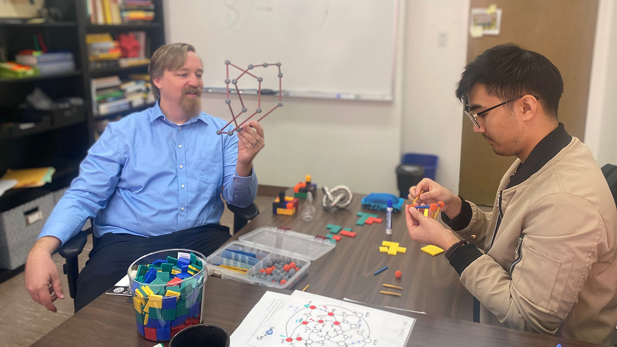 Dr. Blair and student manipulating 3-d models