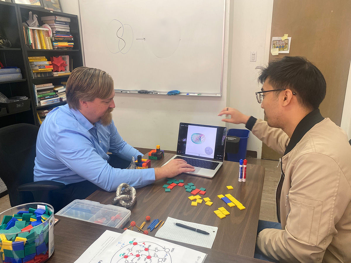 Dr. Blair and student researcher discussing Hopf fibrations