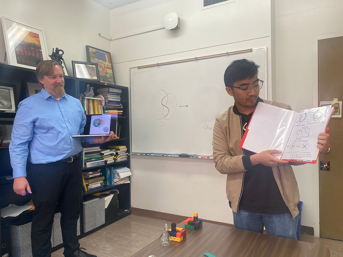 Graduate student Rio discussing thesis ideas with Dr. Blair