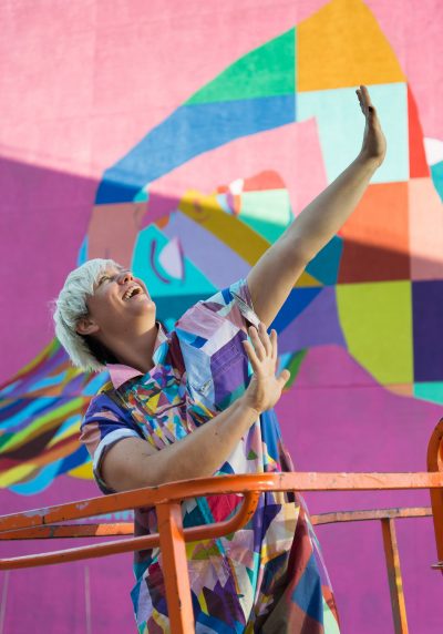 C. Finley in front of her mural