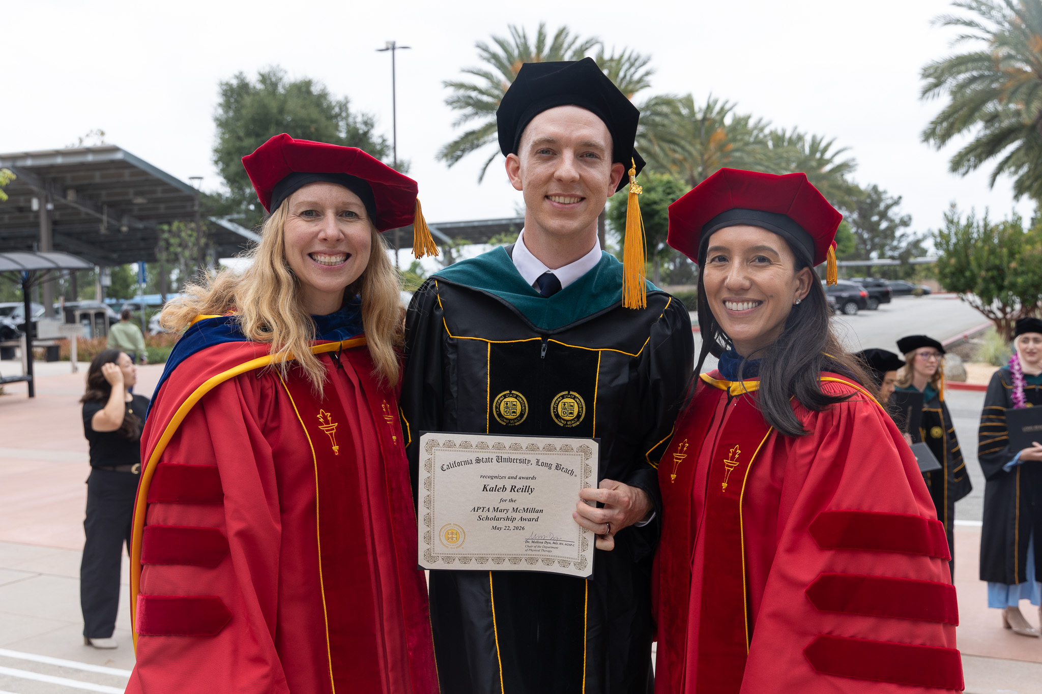 Kaleb Reilly with faculty members