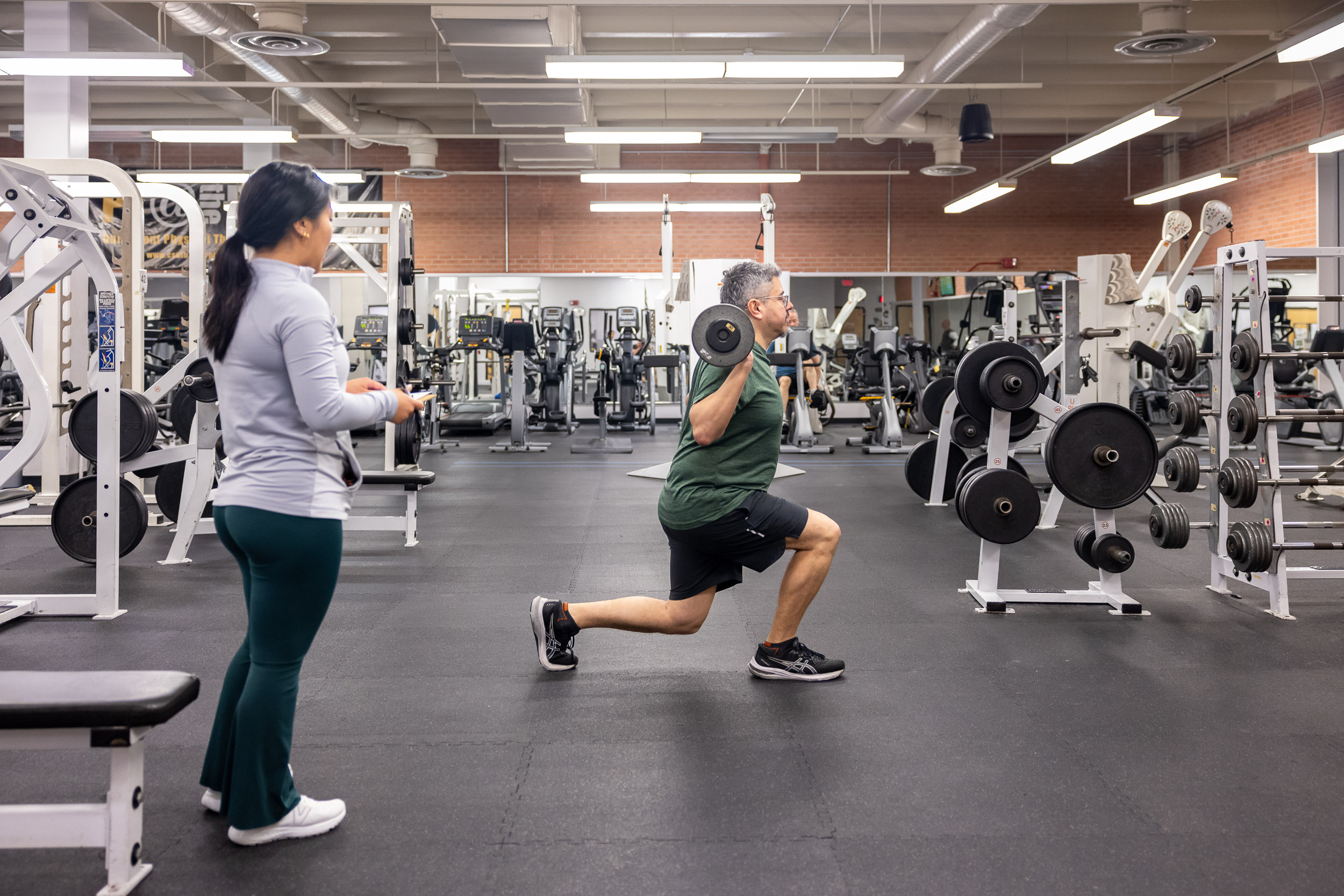 Students lifting weights in the Student Recreation and Wellness Center