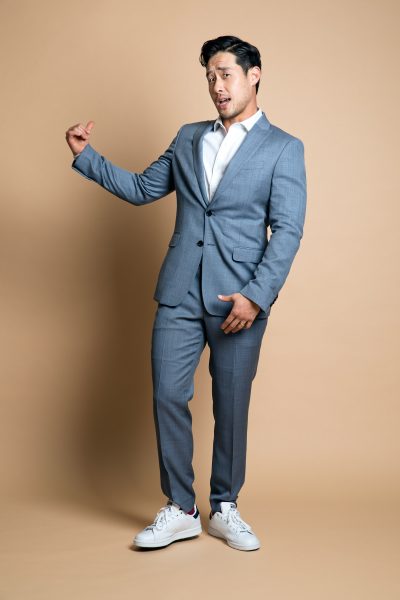 Actor Raymond Lee pointing away