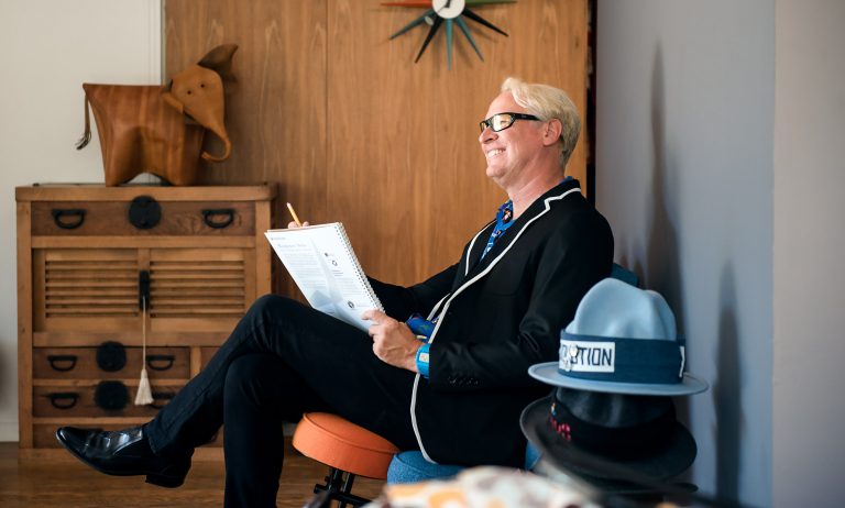 Josh Agle sitting in a chair