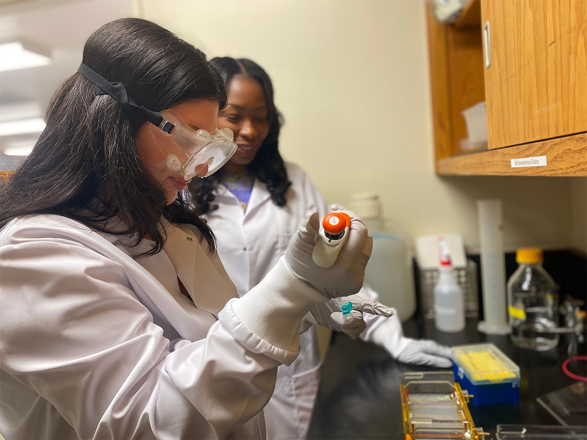 Dr. Lamar Thomas guiding Julia during a lab procedure