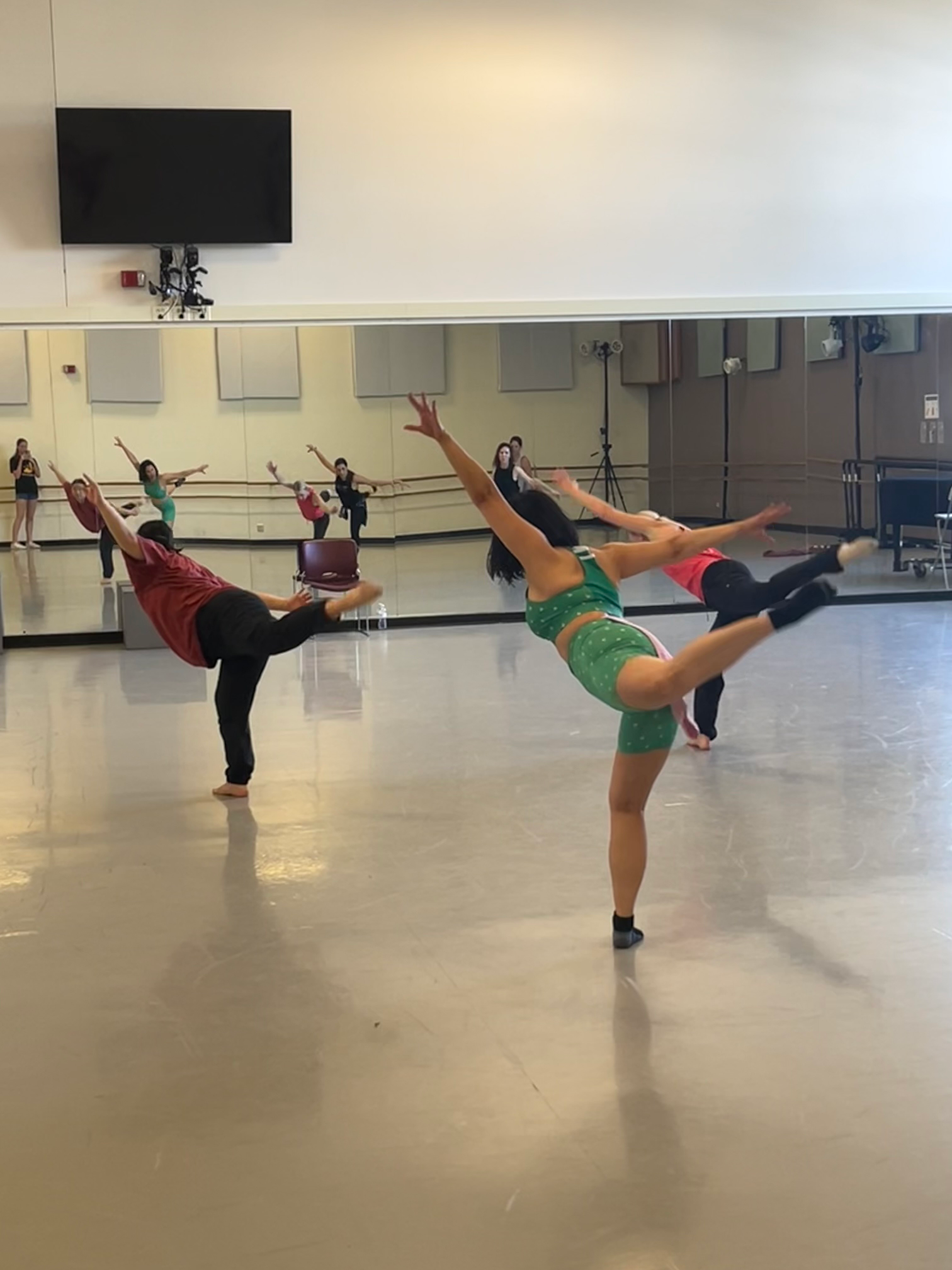 Dancers perform in a large studio