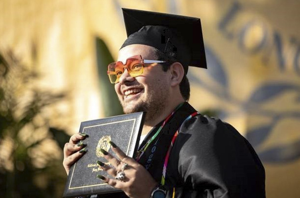 Graduating Student Holding Up Diploma