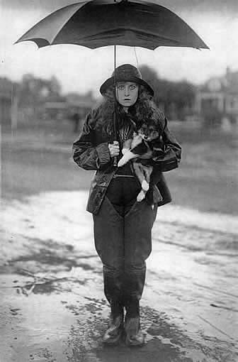 Jackie Saunders in Rain With Umbrella and Dog