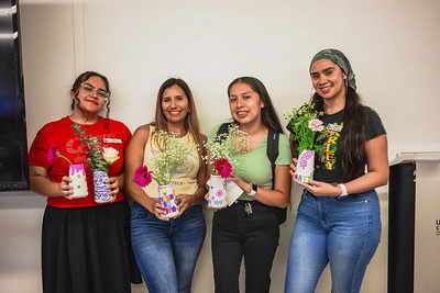 Attendees posing with bouquets they created.