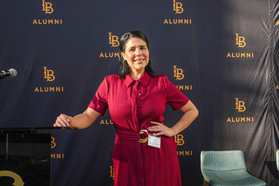 Joanna Mendez posing at a podium.