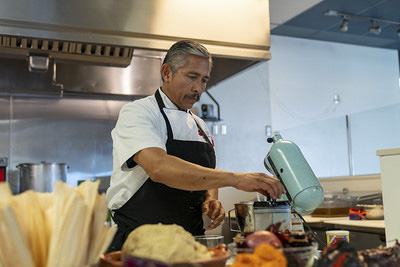 Demonstrator making tamales.