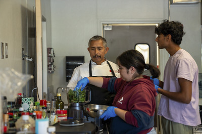 Attendees making tortillas.