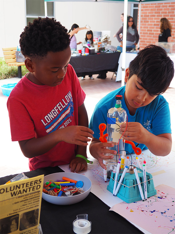 young children assembling a robot