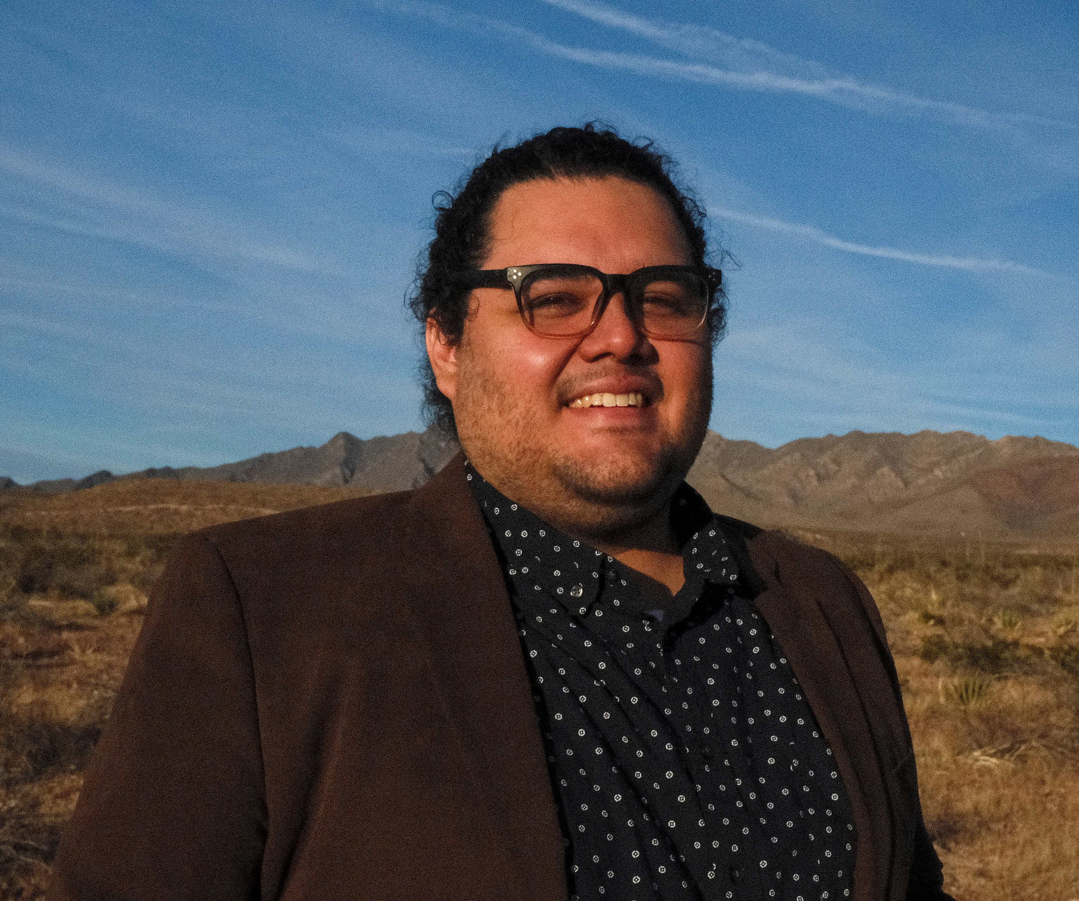 Dr. Roger Renteria in front of desert landscape