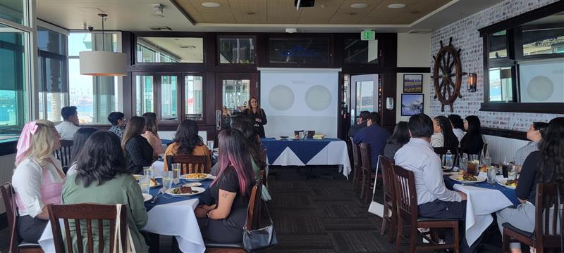 Group of students listening to presenter at a restaurant