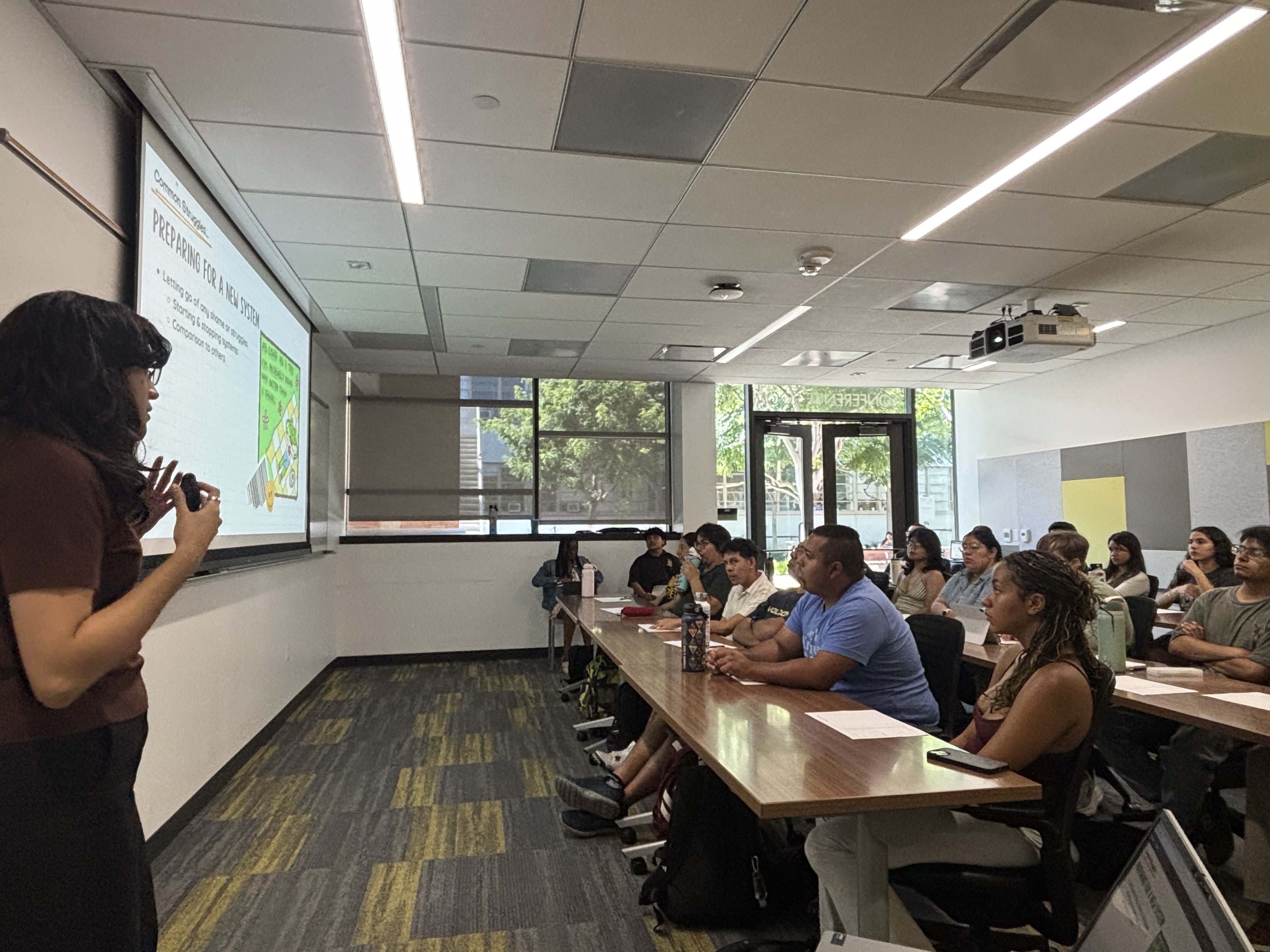 Presenter speaking in front of a class full of students