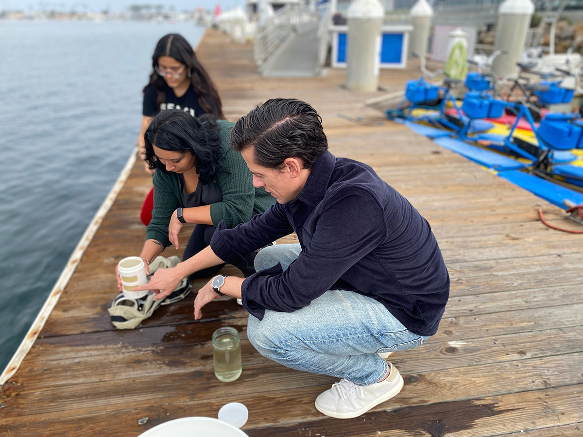 Carlson lab researcher gathering samples of seawater