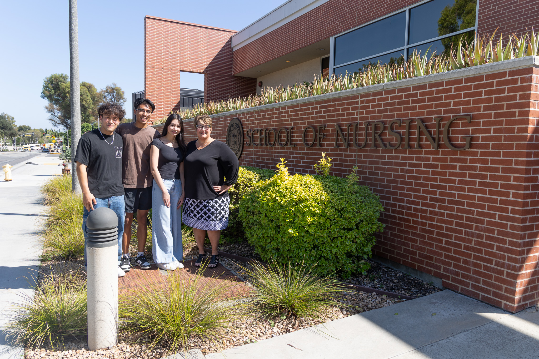 School of Nursing award recipients pose in front of nursing building