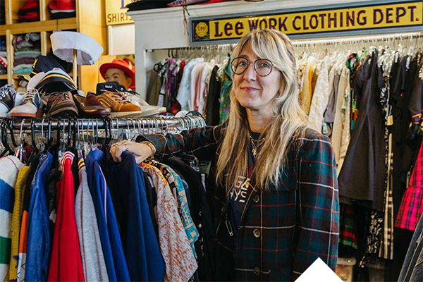  Amy Parris '07 standing buy clothes rack