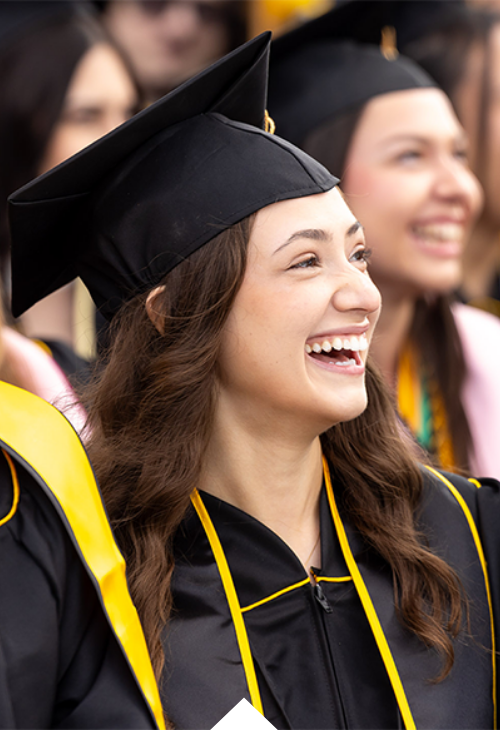 Graduate smiling and laughing during Commencement