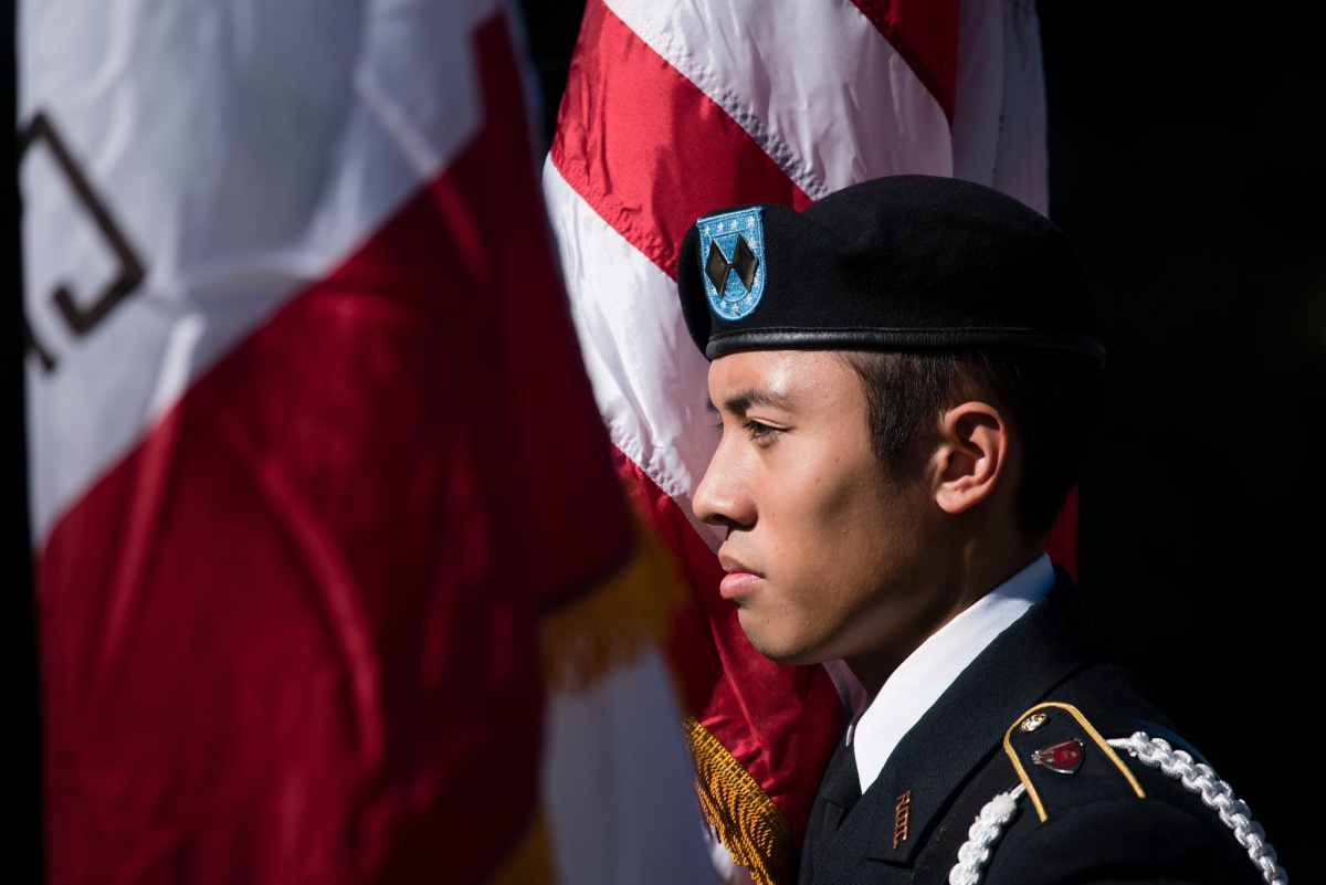 22930674525_a9568673df_k.jpg ROTC member in front of flag