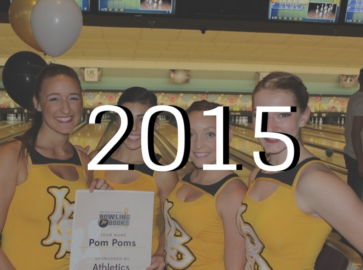 Cheerleaders holding 2015 sign at bowling for books 2015