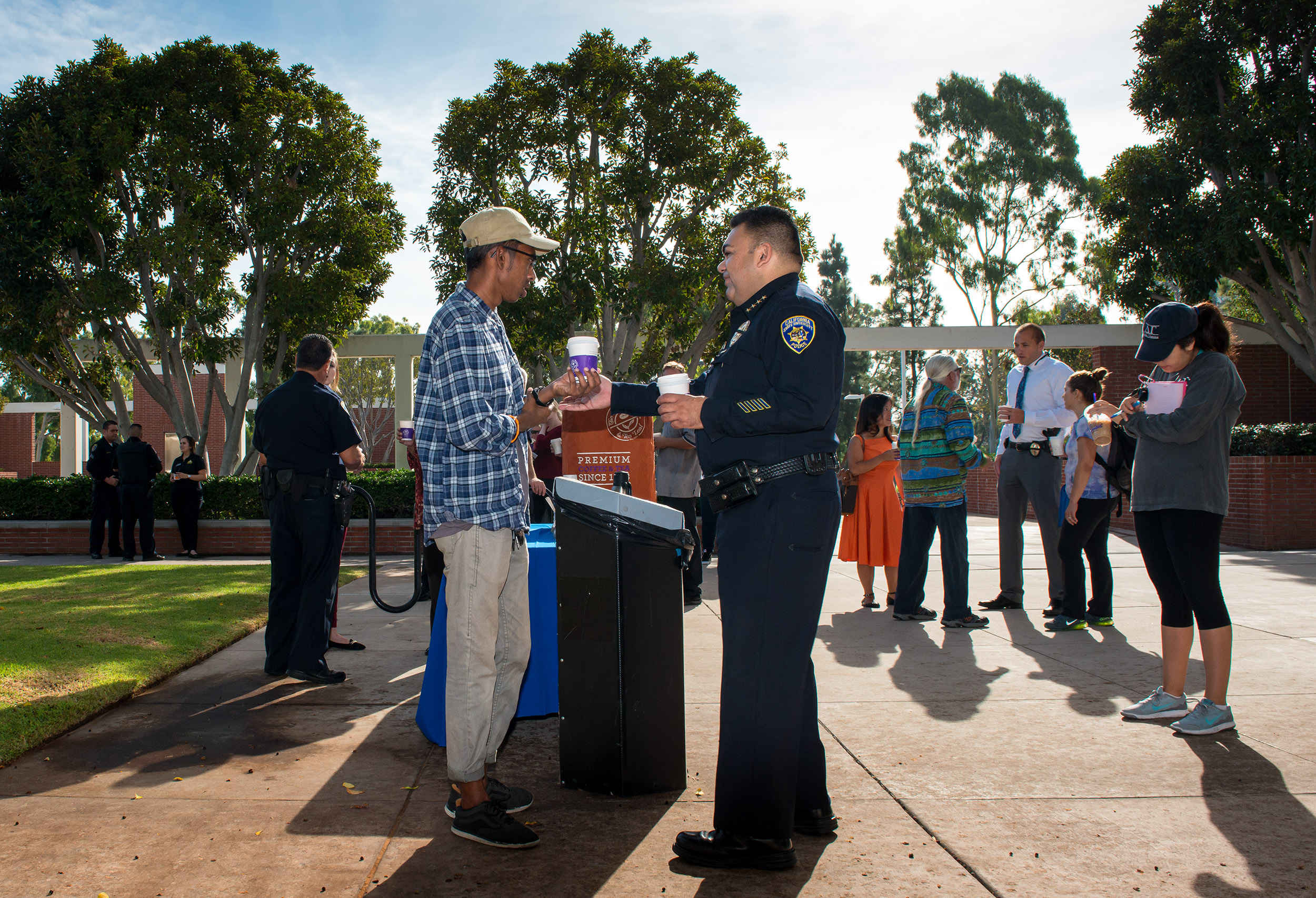 Student shares cup of coffee with police officer