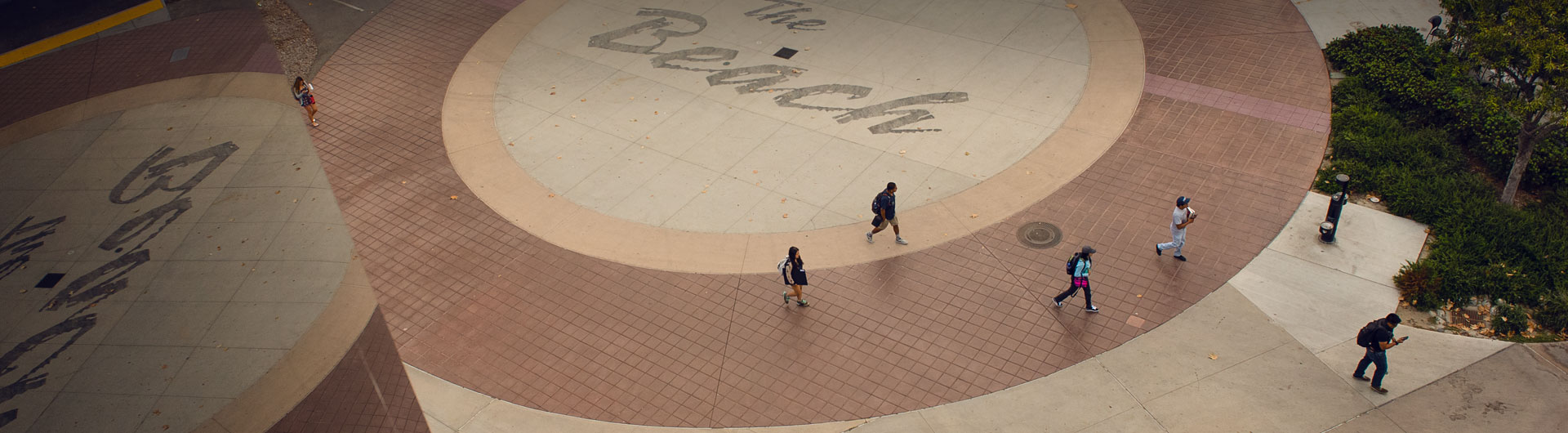 Students walk by The Beach sign on campus