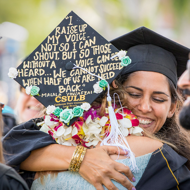 Fellow graduates hug