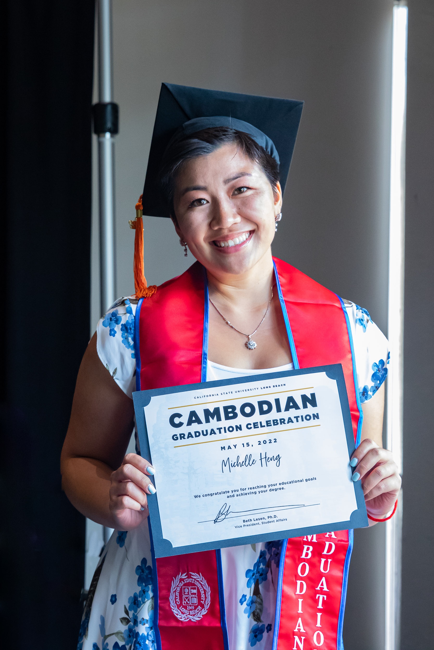 Cambodian student holds up diploma