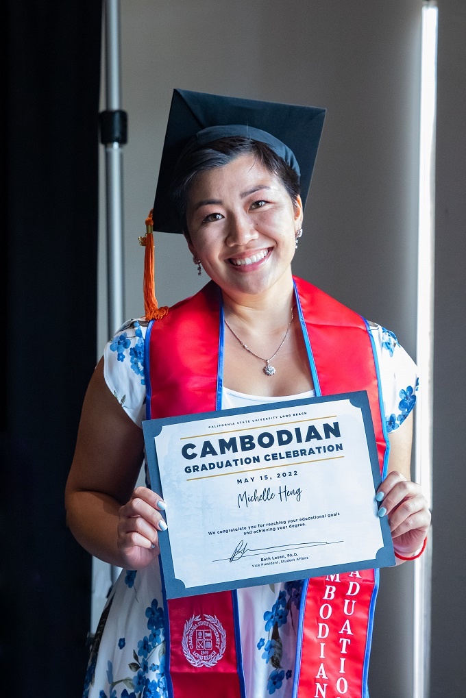 A graduate poses with her diploma at the  2022 Cambodian Cul