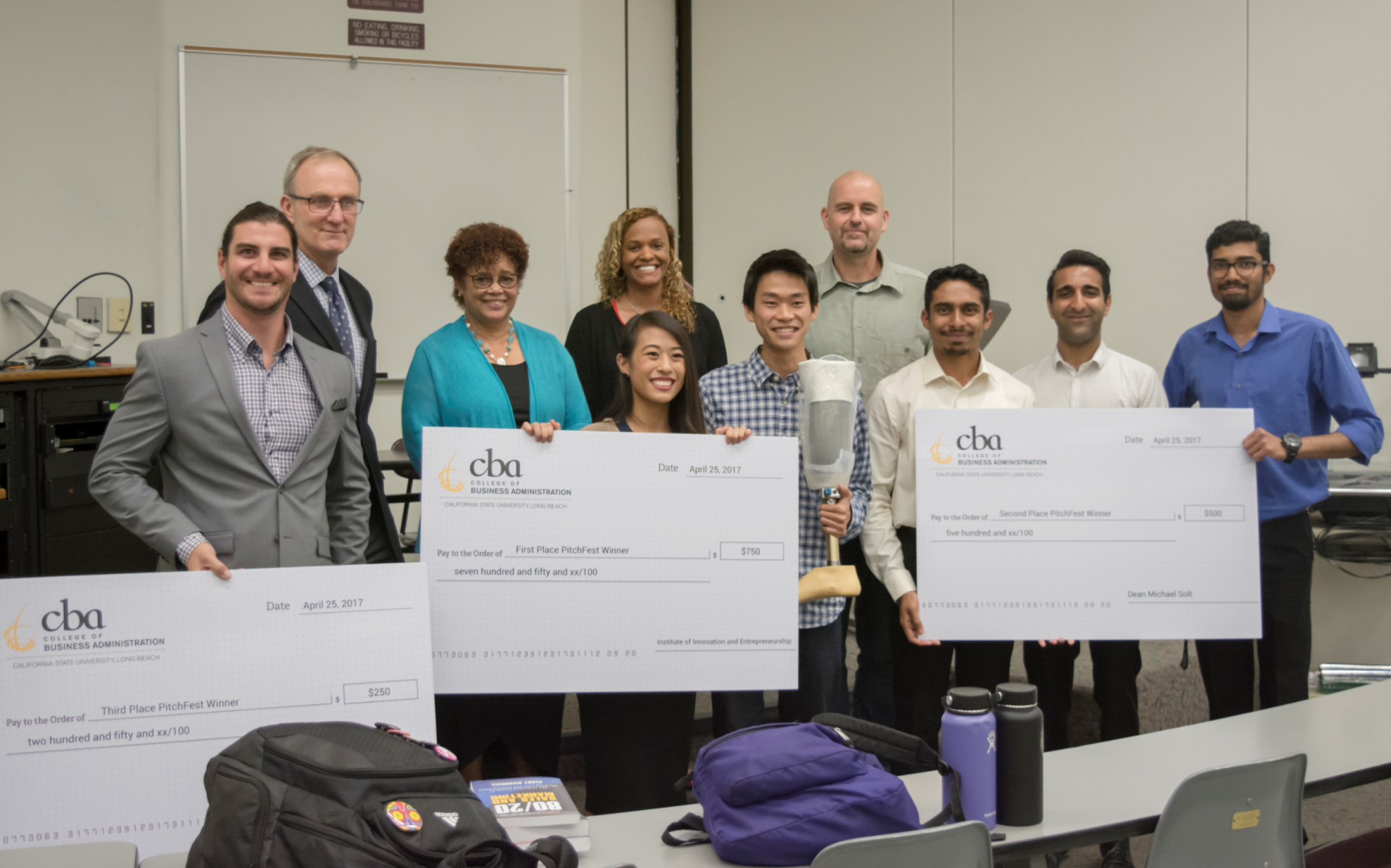 capture_4.png 2017 PitchFest judges and winners holding their oversized ch