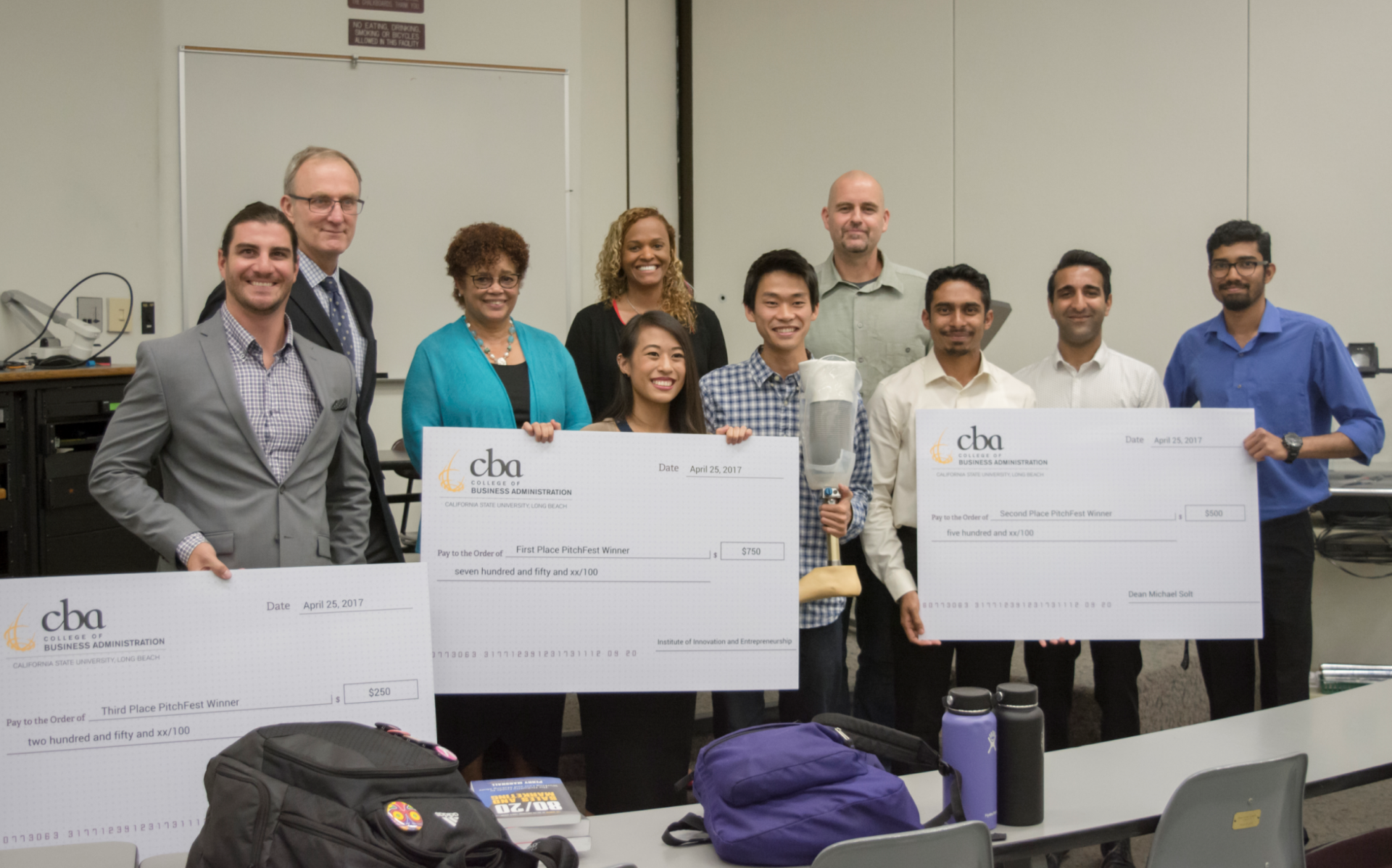 2017 PitchFest judges and winners holding their oversized ch