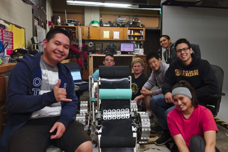 Team posing with the mining robot