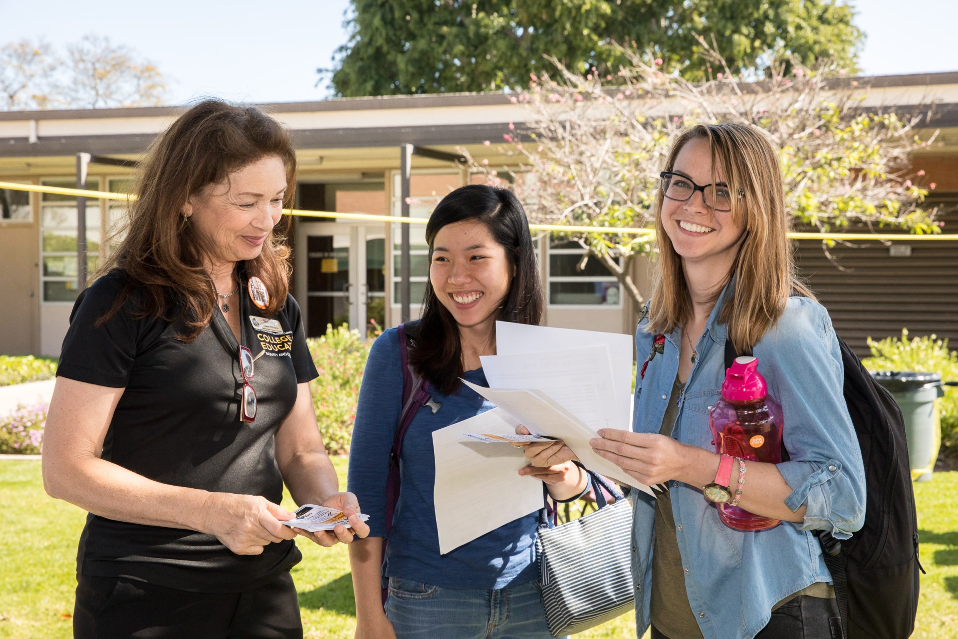 Students and staff member smiling