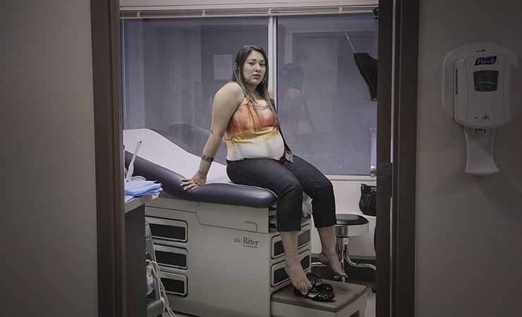 screen shot - young pregnant woman in the clinic