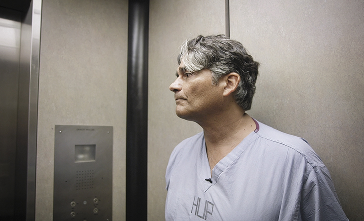 screen shot - male medical professional in an elevator