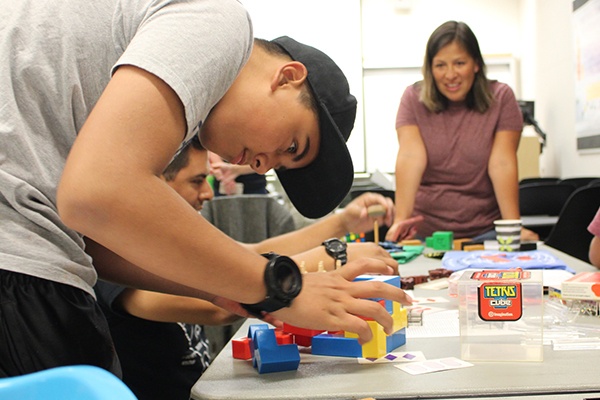 person working on a math puzzle with blocks